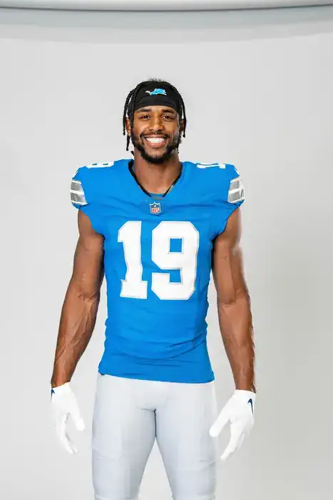 Professional football player in full uniform, studio portrait